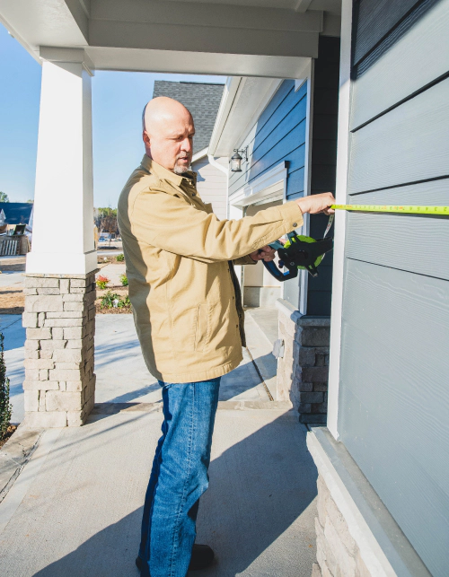 man measuring house entrance for appraisal raleigh nc